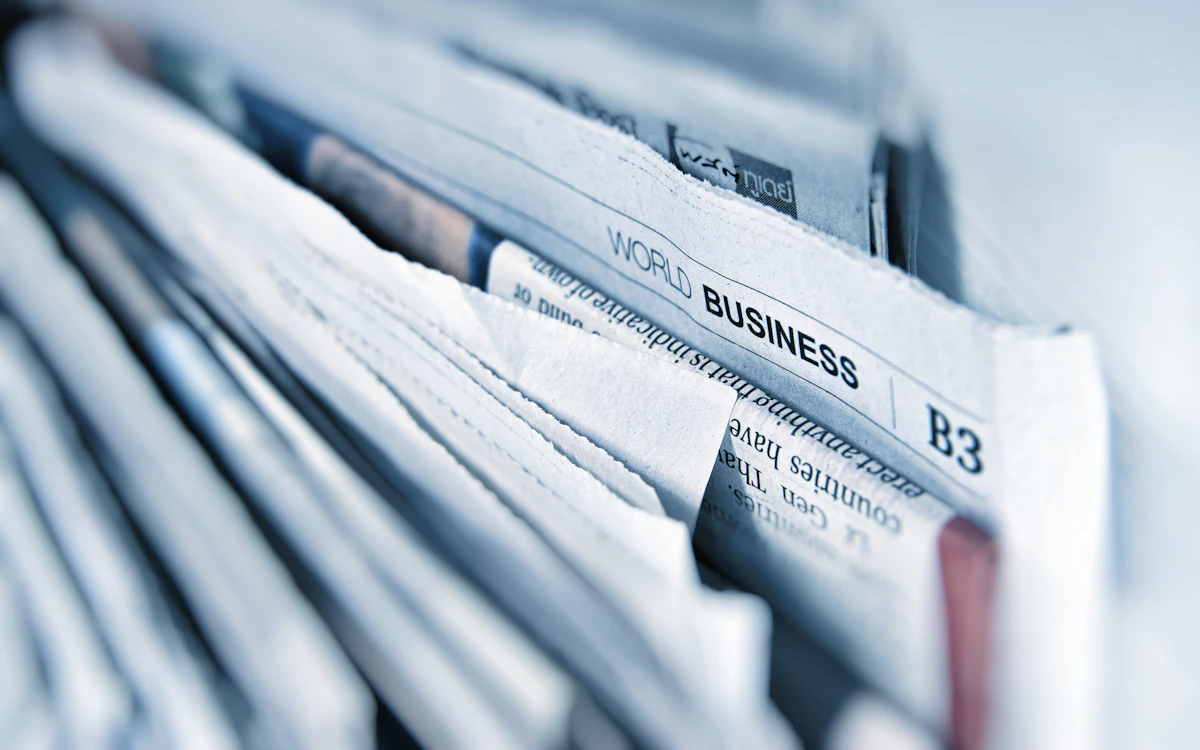 Stack of folded newspapers representing a fundraising industry news roundup