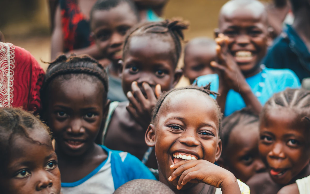 Smiling children expressing joy, illustrating the impact donors help create