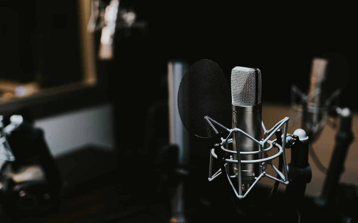 Two people recording a podcast interview together at a desk