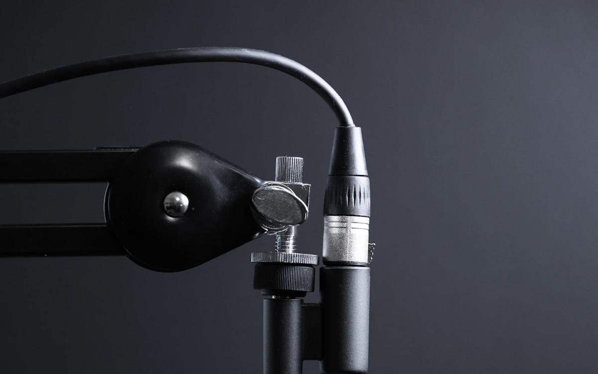 Podcast host speaking into a studio microphone during a recording
